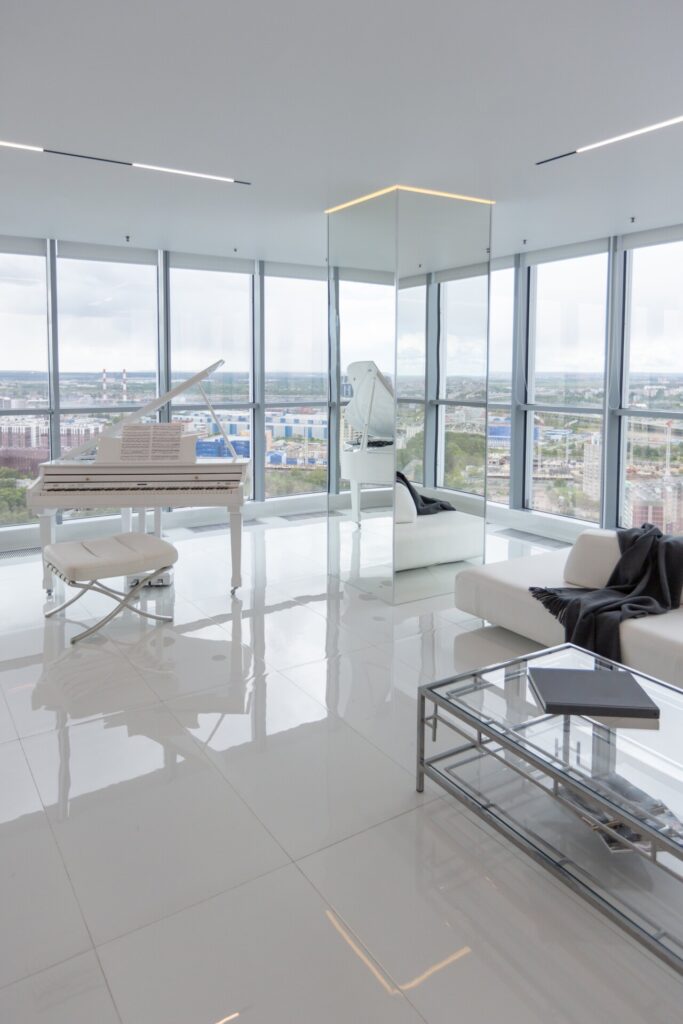 white-very-bright-luxury-fashionable-apartment-high-floor-with-free-layout-living-room-with-expensive-furniture-panoramic-glazing-min